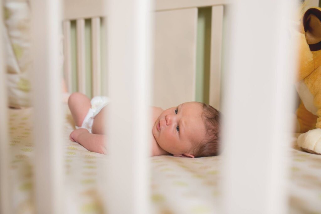 awake newborn in crib, york pa birth doula/photographer